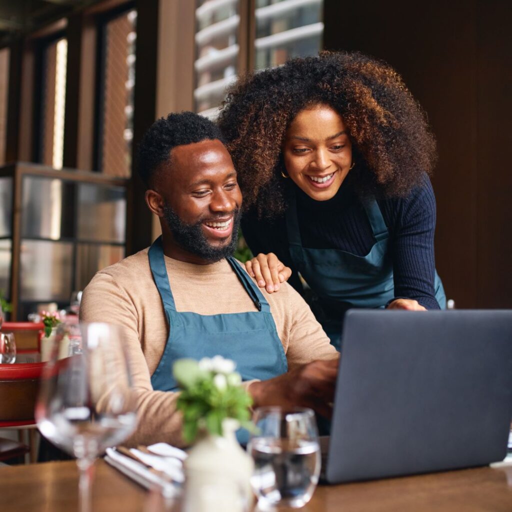 Business owners smiling at finances